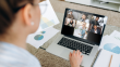 Women video conferencing with a team of people on her laptop