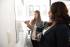 2 women in business attire writing on a whiteboard